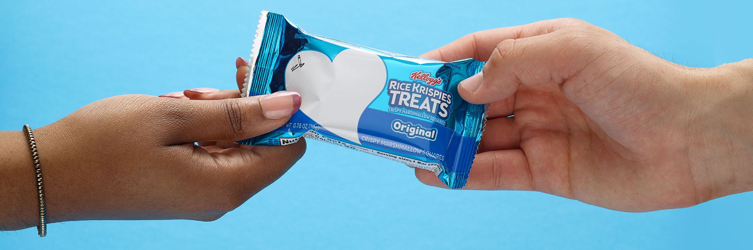 two different hands holding a Rice Krispies Treats® on each end